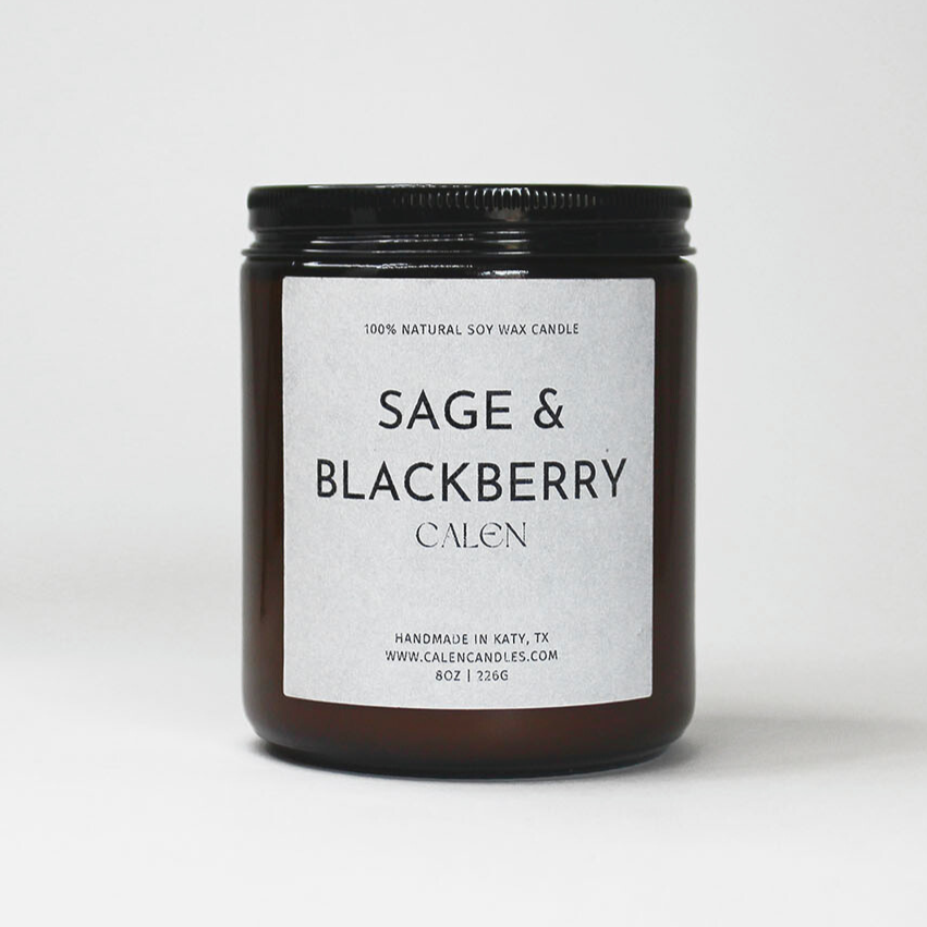 Candle jar labeled 'Sage & Blackberry' on a white background